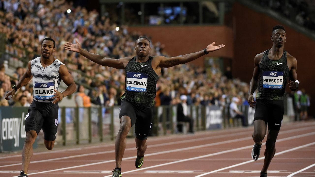 Coleman raises his arms in celebration after winning the men's 100m final of the Memorial Van Damme athletics event.