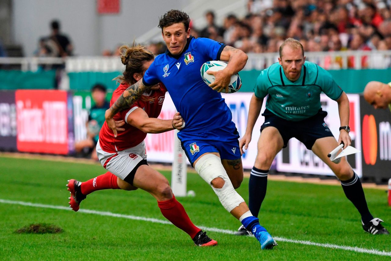 Canada's wing Jeff Hassler (back) tackles Italy's full back Matteo Minozzi during Group B game.