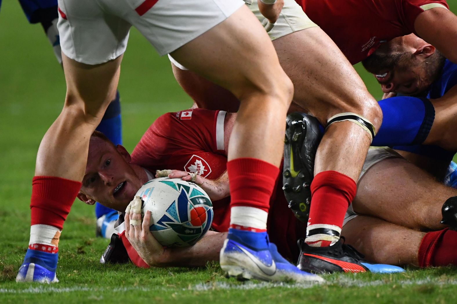 Canada's fly-half Peter Nelson hands over the ball in a ruck.