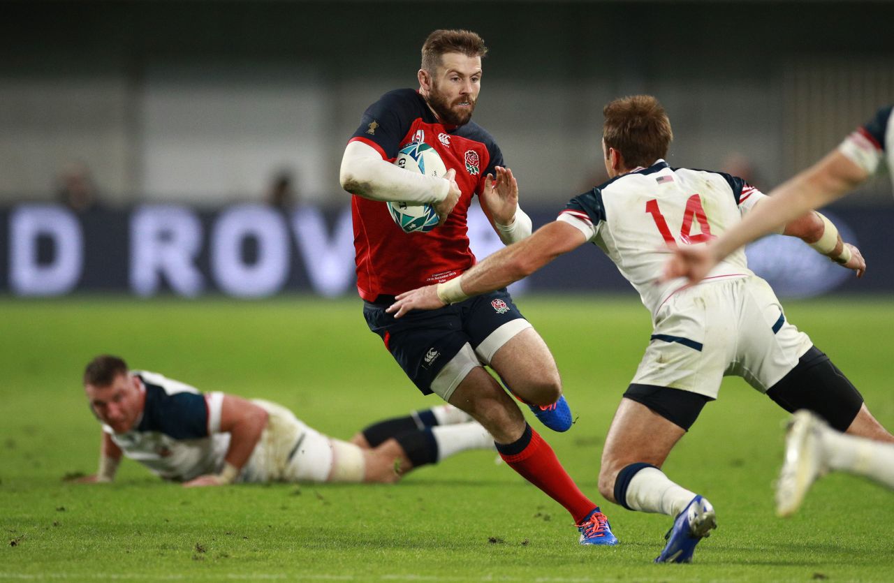 Elliot Daly of England is tackled by Blaine Scully, who is captain of the USA team.