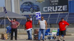 Picketers carry signs at one of the gates outside the closed General Motors automobile assembly plant, Monday, Sept. 16, 2019, in Lordstown, Ohio. (AP Photo/Keith Srakocic)