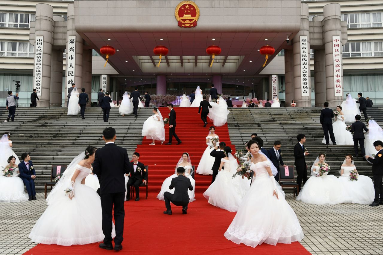 Couples attend a mass wedding at a municipal government building in Jiaxing, China, on Sunday, September 22. 
