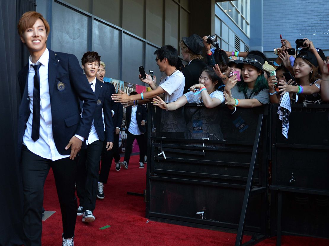 Members of Korean K-pop group BTS arrive on the red carpet during the K-CON 2014 at the Los Angeles Memorial Sports Arena on August 10, 2014.  