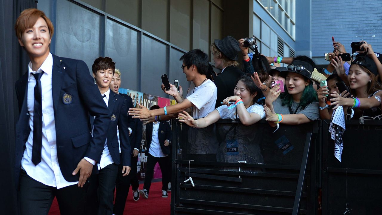 Members of Korean K-pop group BTS arrive on the red carpet during the K-CON 2014 at the Los Angeles Memorial Sports Arena on August 10, 2014.  