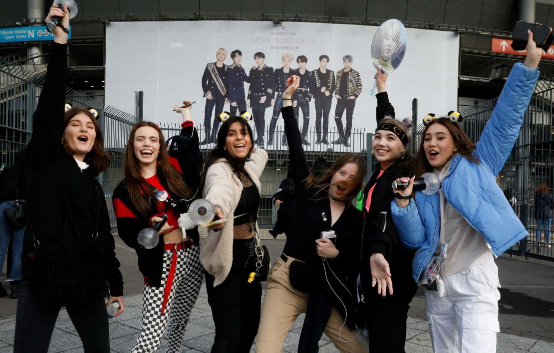 Fans react as they arrive for a concert of the South Korean K-pop boy band BTS at the Stade-de-France stadium in Saint-Denis, on the outskirts of Paris, on June 7, 2019. 