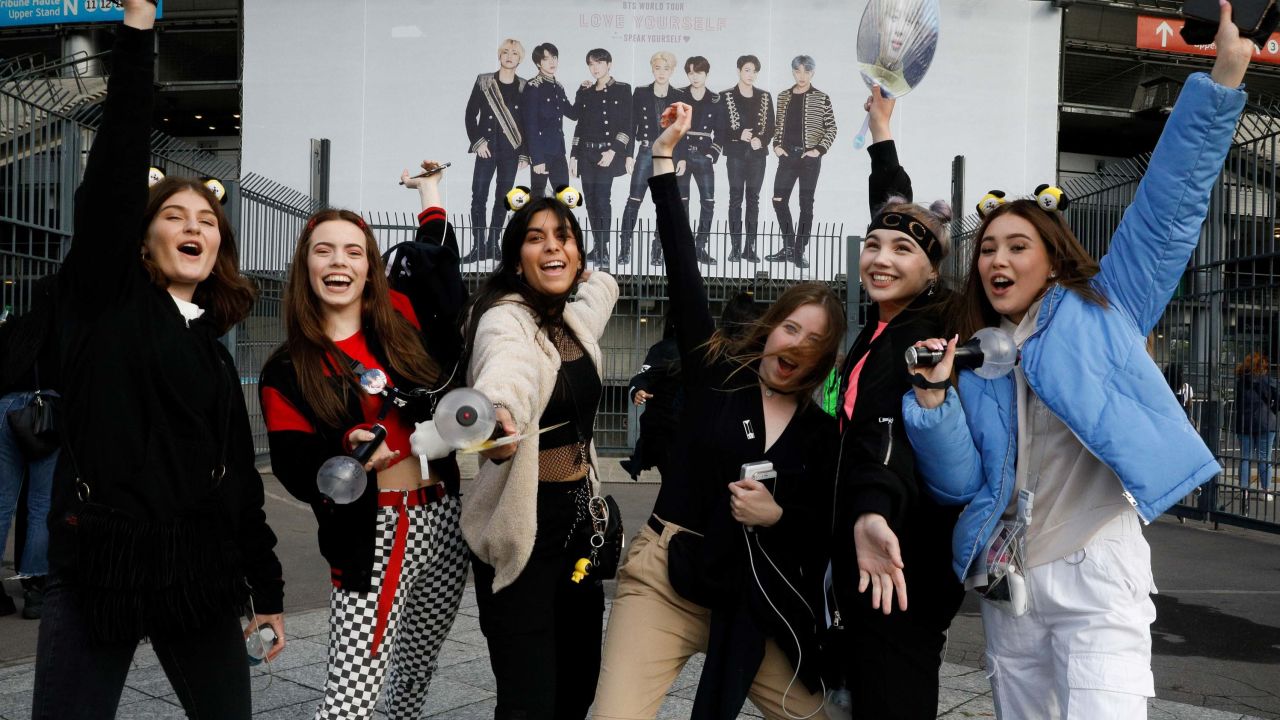 Fans react as they arrive for a concert of the South Korean K-pop boy band BTS at the Stade-de-France stadium in Saint-Denis, on the outskirts of Paris, on June 7, 2019. 