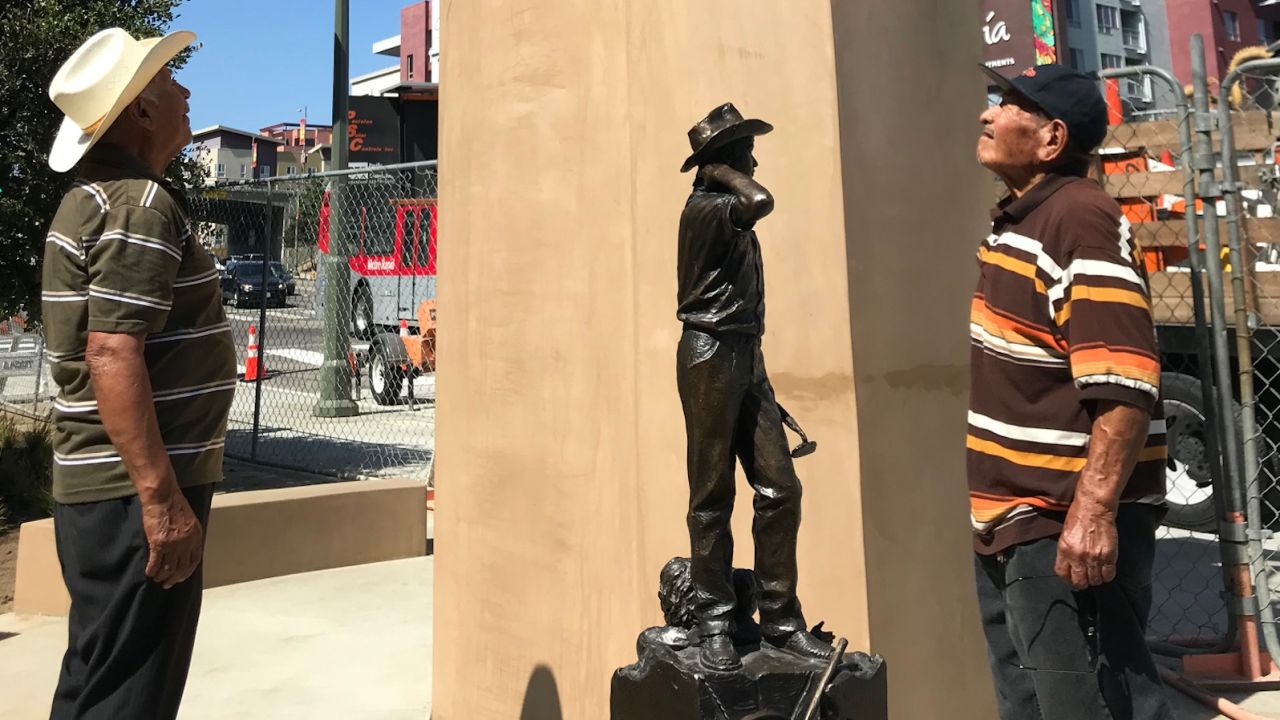 Ramon Zapata, 82, and Leobardo Villa, 85, both former participants in the Bracero Program, look at the pedestal where a monument honoring braceros will be unveiled in Los Angeles. A smaller-scale model of the monument is also at the site.
