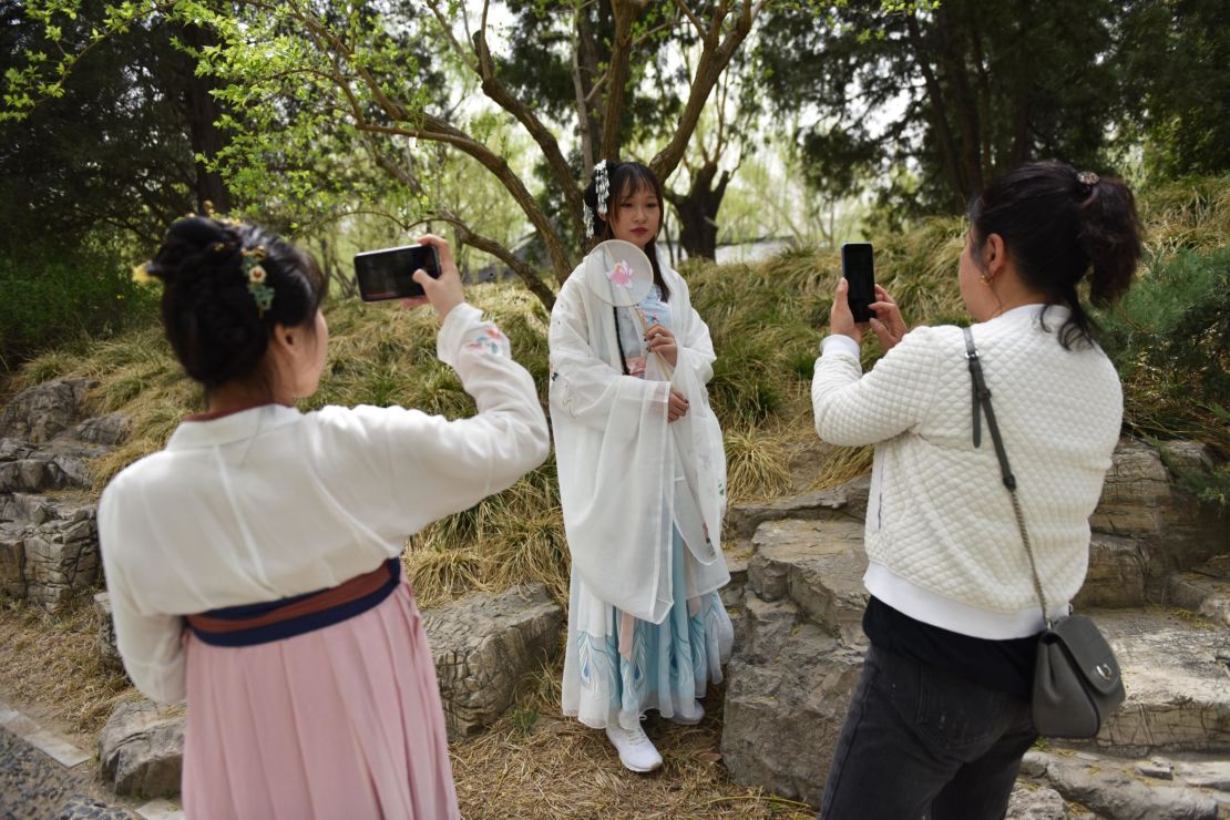 Hanfu fans pose for photographs.