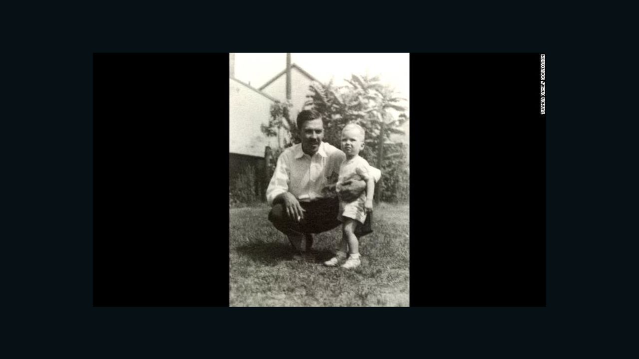 Turner is seen with his father, Ed, at approximately 10 to 14 months old.