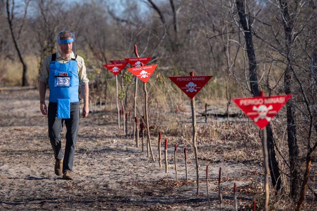 Harry walks through a minefield in Dirico, Angola, on Friday, before traveling to the site of his mother's famous photos.