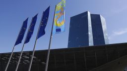 The stars of the European Union (EU) sit on banners as they fly alongside a banner commemorating the 20th anniversary of the euro currency outside the European Central Bank (ECB) headquarters following a rates decision news conference with ECB President Mario Draghi in Frankfurt, Germany, on Thursday, July 25, 2019. The ECB sent its strongest signal yet that monetary support for the euro-area economy will be stepped up after the summer break, with lower interest rates and renewed asset purchases on the table. Photographer: Alex Kraus/Bloomberg via Getty Images