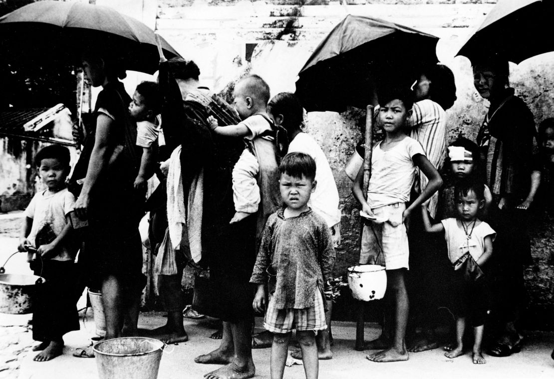 Chinese refugees queuing for a meal in Hong Kong in May 1962, after fleeing mass famine on the mainland.