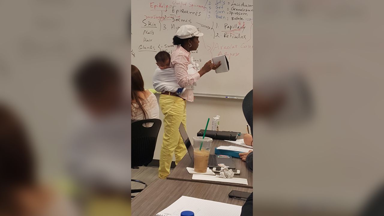 College professor Ramata Sissoko Cissé teaches an anatomy course with one of her student's children strapped to her back.