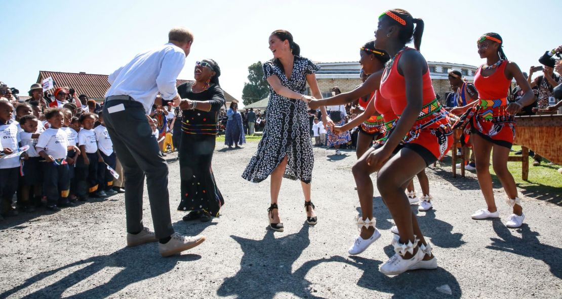 The Duke and Duchess of Sussex dance during their visit to the Justice Desk in Johannesburg.