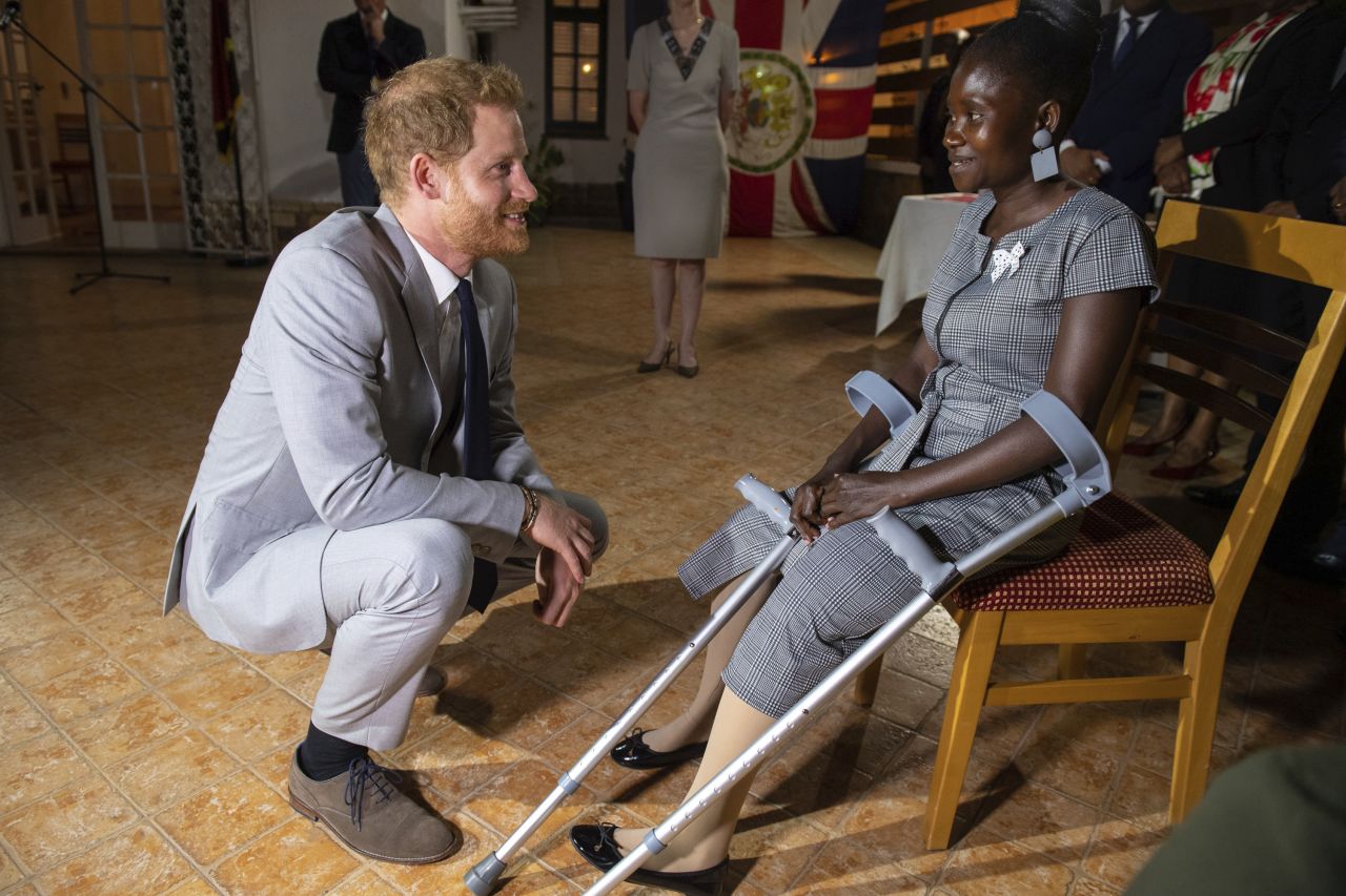Britain's Prince Harry meets landmine victim Sandra Tigica <a href="https://www.cnn.com/2019/09/23/world/gallery/royals-africa-tour/index.html" target="_blank">while visiting Luanda, Angola,</a> on Friday, September 27. Tigica also met Harry's mother, Diana, during her visit to Angola in 1997. 