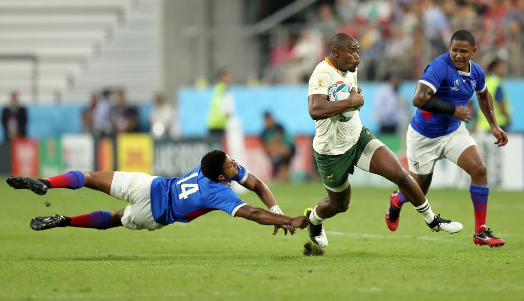Makazole Mapimpi of South Africa evades a tackle from Chad Plato of Namibia to go on and score his team's seventh try.