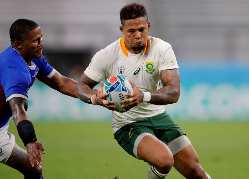 South Africa's Elton Jantjies runs past Namibia's Eugene Jantjies during the one-sided match.