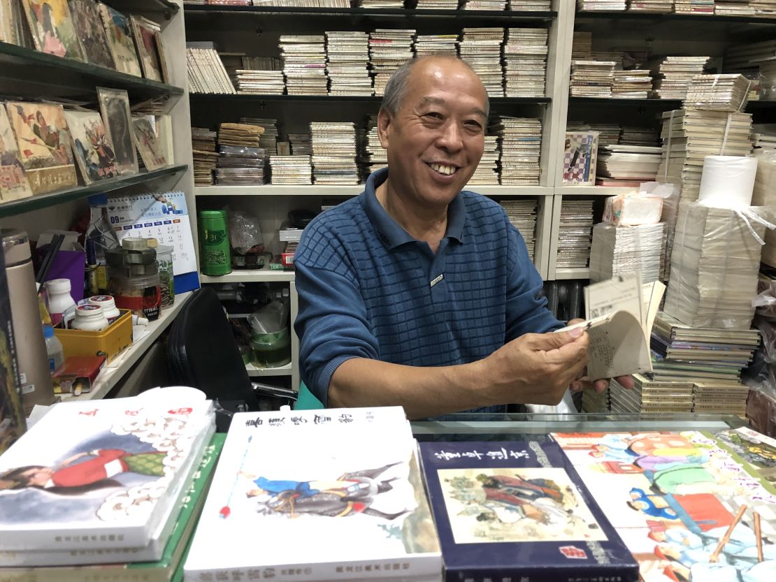 Ma sitting in his "lianhuanhua" comic book store in Beijing in September, surrounded by his life's work.
