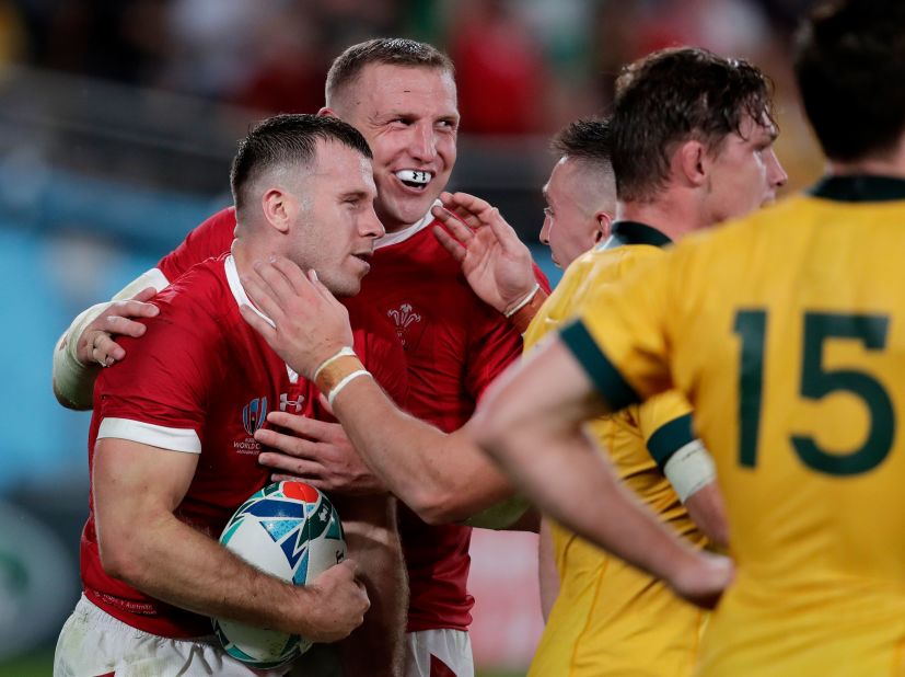 Wales' Gareth Davies (left) is congratulated by teammate Hadleigh Parkes after scoring his crucial interception try during a 29-25 win over Australia in the Rugby World Cup Pool D game at Tokyo Stadium.