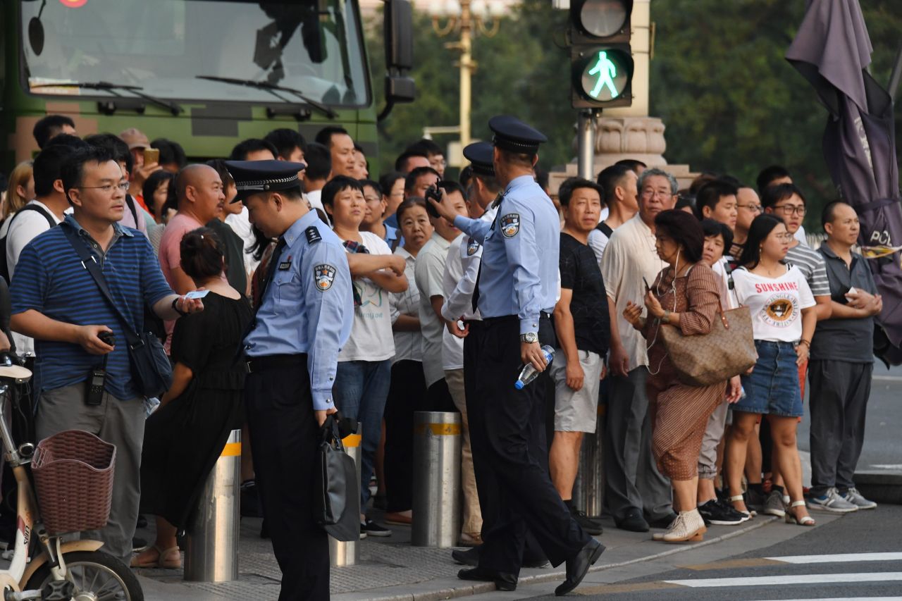 Chinese police block off a street corner in front of a military truck next to Tiananmen Square ahead of an overnight rehearsal on September 7.