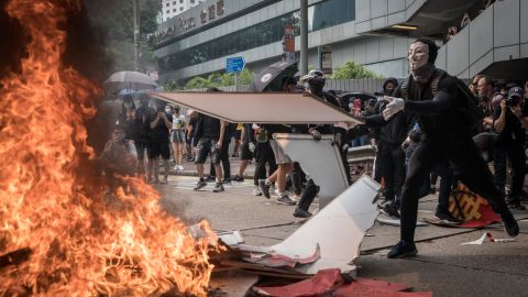 A pro-democracy protester burns a banner during a march in Hong Kong.