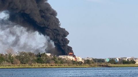 The fire appears to have engulfed multiple waterfront properties, according to pictures and video from Surf City Police's Twitter account.