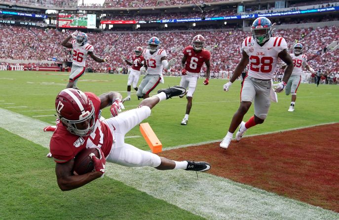 Alabama Crimson Tide wide receiver Jaylen Waddle gets knocked out of the end zone by Ole Miss defensive back Kediron Smith during the second quarter of their NCAA football game at Bryant-Denny Stadium in Tuscaloosa, Alabama, on September 28.