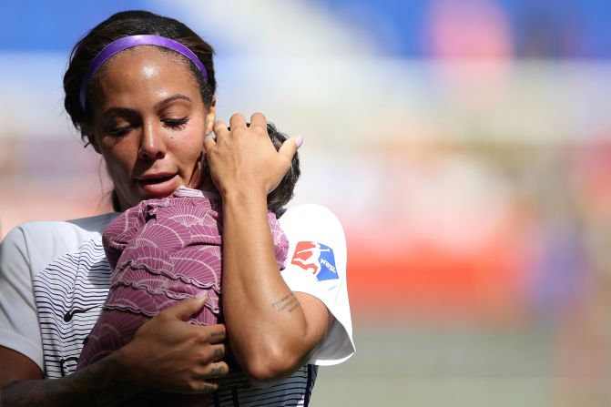 Orlando Pride forward Sydney Leroux holds her child on the pitch after a soccer match against Sky Blue FC in Harrison, New Jersey, on Sunday, September 29. Leroux returned the field for Orlando for the first time since giving birth three months ago.