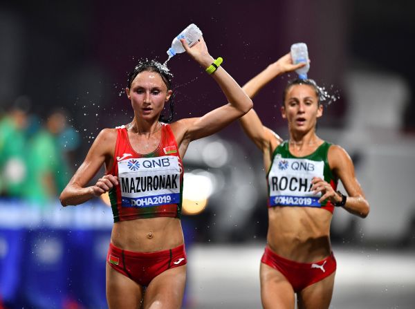 Belarus' Volha Mazuronak and Portugal's Salome Rocha pour bottles of water on their head during the women's marathon at the IAAF World Athletics Championships Doha 2019 in Doha, Qatar, on September 28.