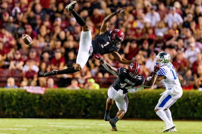 Jaycee Horn and Sherrod Greene of the South Carolina Gamecocks attempt to intercept a pass intended for Asim Rose of the Kentucky Wildcats during the second half of a game at Williams-Brice Stadium in Columbia, South Carolina, on September 28. South Carolina defeated Kentucky 24-7.
