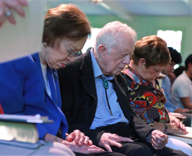 Jimmy and Rosalynn Carter bow their heads in prayer at a church in Plains, Georgia, in June 2019. It was less than a month after the former president fell and broke his hip.