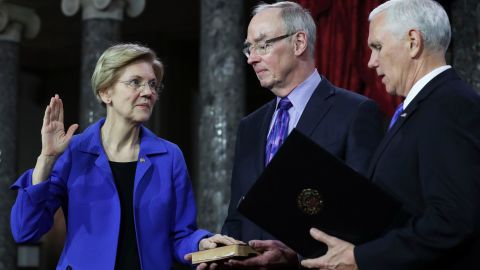 US Senator from Massachusetts (D) Elizabeth Warren is flanked her husband Bruce Mann as she is sworn in by Vice President Mike Pence.