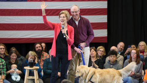Sen. Elizabeth Warren onstage which her husband Bruce Mann and dog Bailey.
