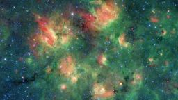 This infrared image from NASA's Spitzer Space Telescope shows a cloud of gas and dust full of bubbles, which are inflated by wind and radiation from massive young stars. Each bubble is filled with hundreds to thousands of stars, which form from dense clouds of gas and dust.