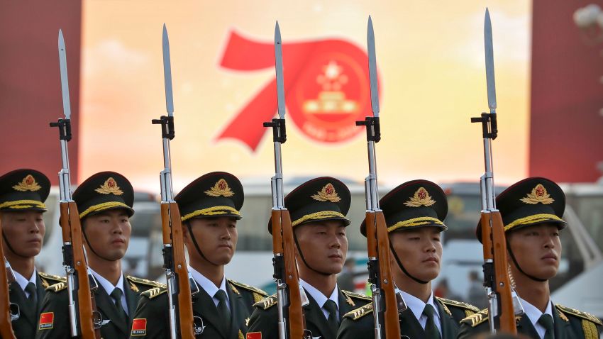Members of a Chinese military honor guard stand at attention during a rehearsal before a large parade to commemorate the 70th anniversary of the founding of Communist China in Beijing, Tuesday, Oct. 1, 2019. Chinese Communist Party leader and President Xi Jinping on Monday renewed his government's commitment to allowing Hong Kong to manage its own affairs amid continuing anti-government protests in the semi-autonomous Chinese territory.