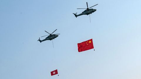Helicopters fly the flags of China and Hong Kong over Victoria Harbour during a flag-raising ceremony at Golden Bauhinia Square in Hong Kong.