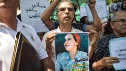 A demonstrator holds up a sign showing the portrait of Hajar Raissouni, a Morrocan journalist of the daily newspaper Akhbar El-Youm, with a caption below in Arabic and English reading "Akhbar El-Youm: no to the abortion of the free press", during a protest outside a courthouse holding her trial on charges of abortion in the capital Rabat on September 9, 2019. (Photo by FADEL SENNA / AFP)        (Photo credit should read FADEL SENNA/AFP/Getty Images)