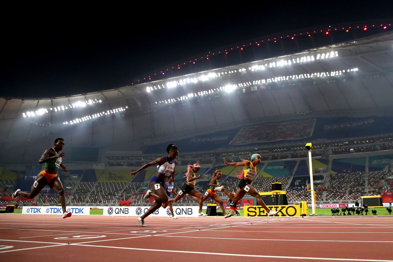 Fraser-Pryce crosses the finish line to win the women's 100 meters final ahead of Dina Asher-Smith. Huge cloths were spread out on the upper tiers of the Khalifa Stadium to mask the empty spaces.