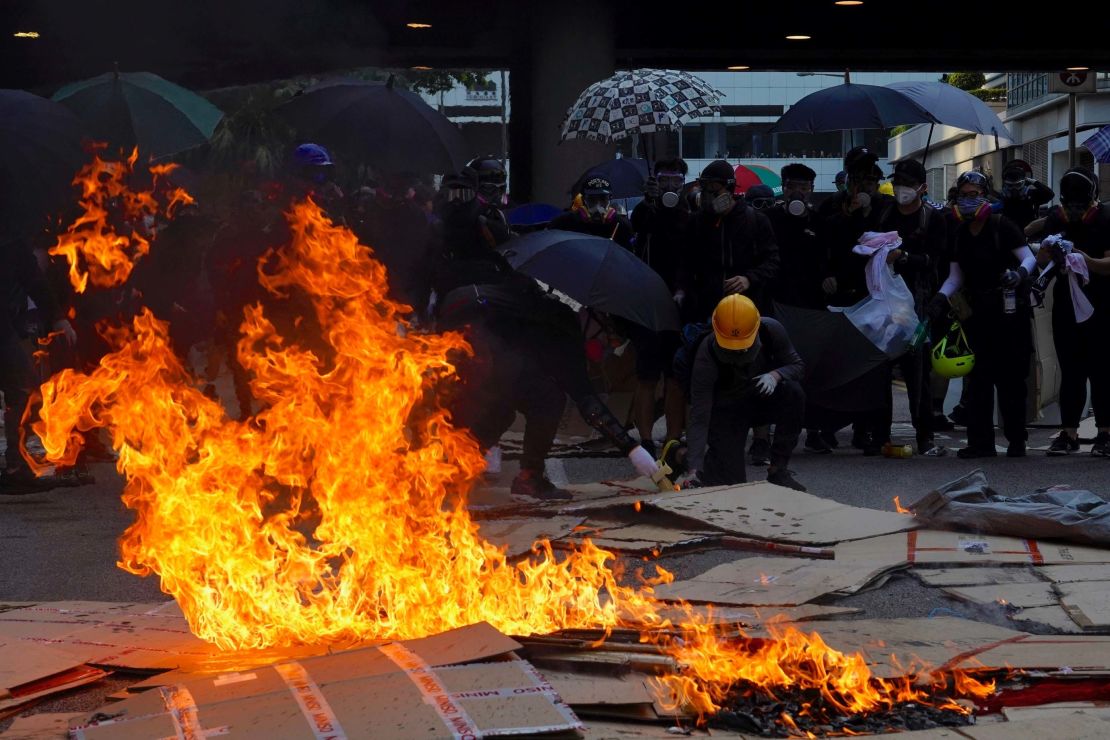 Anti-government protesters set fire to cartons outside government headquarters in Hong Kong.