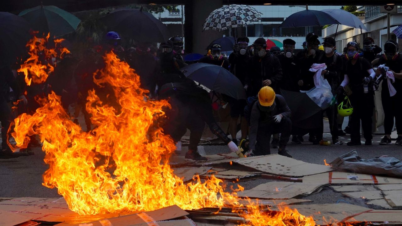 Anti-government protesters set fire to cartons outside government headquarters in Hong Kong.