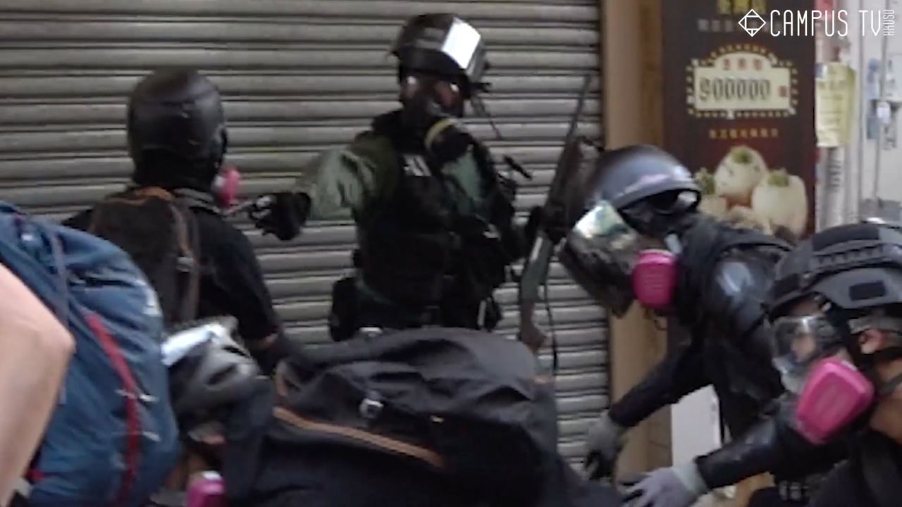 This video appears to show the moment a police officer shot a person who appears to be protesting on Tuesday in Hong Kong. The video also appears to show the individual striking the police officer with a pole just before the officer deployed his firearm. A police source confirmed CNN that a man was shot with a live round by police in the Tsuen Wan district of Hong Kong on Tuesday afternoon. The man's condition is currently not known, CNN have approached police for an official statement.