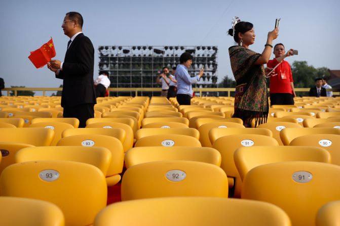 Attendees take photos as they arrive for the commemoration events in Beijing.