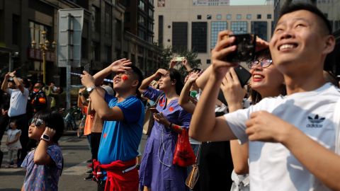Residents watch Chinese military planes fly in formation above the capital city.