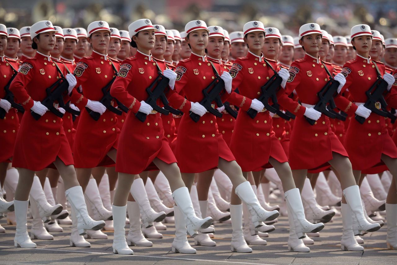 Chinese female militia members march in formation.