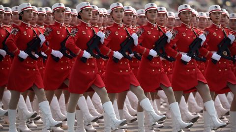 Chinese female militia members march in formation.