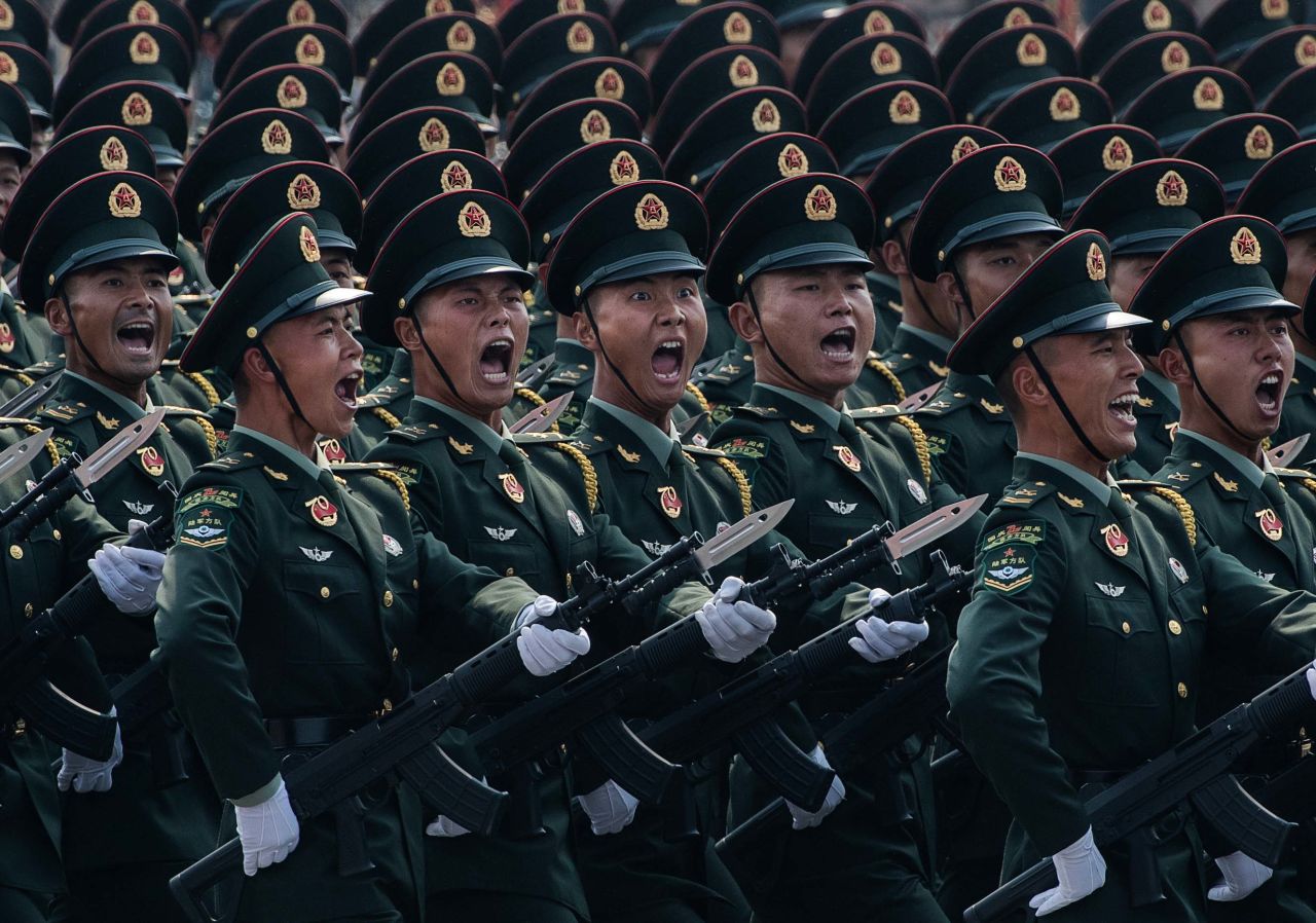 Chinese soldiers shout as they march in formation during the 70th anniversary parade.