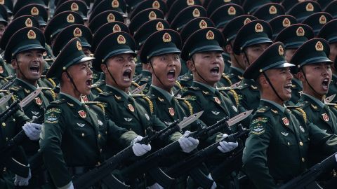 Chinese soldiers shout as they march in formation during the 70th anniversary parade.