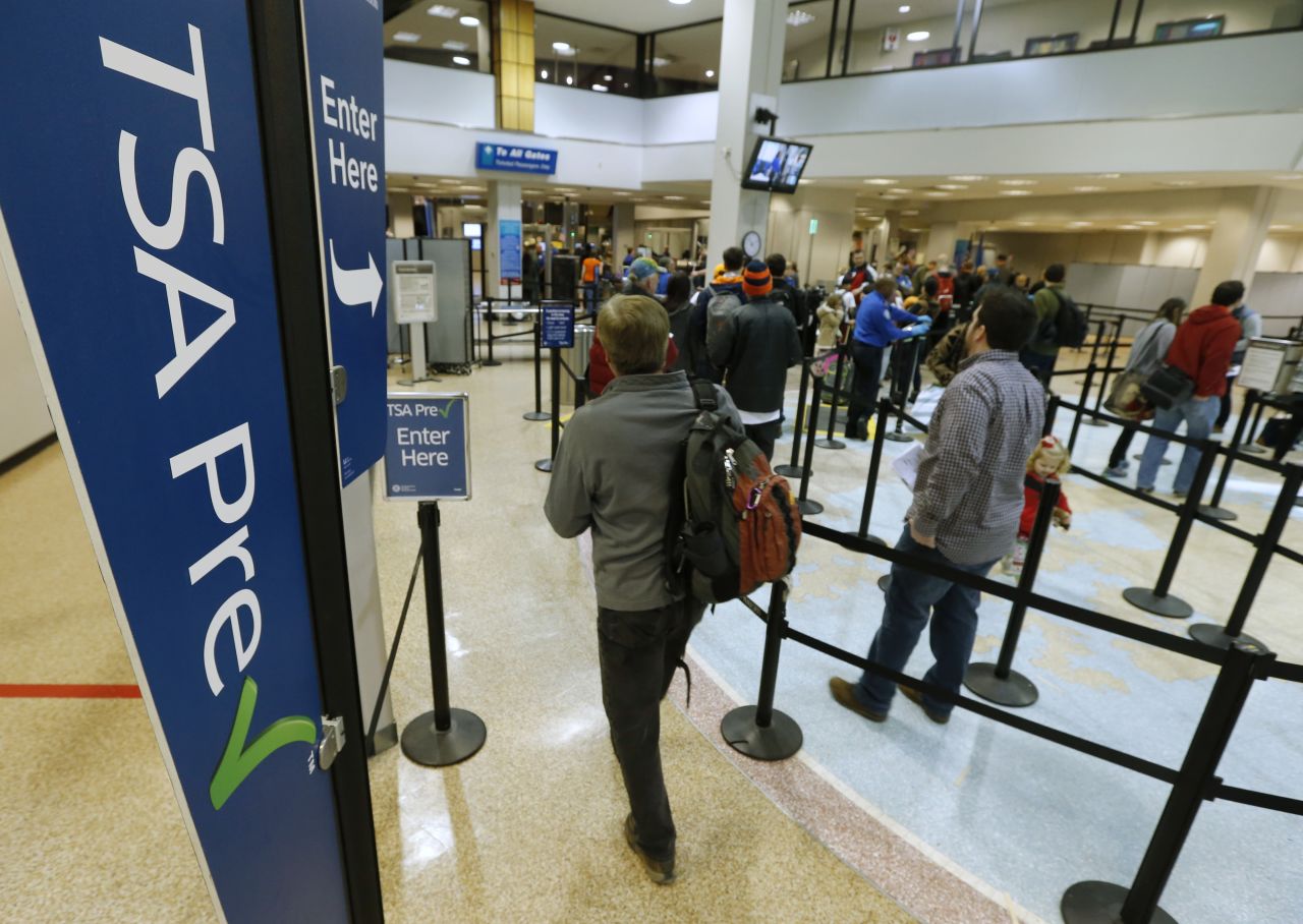A passenger enters the TSA PreCheck line at an airport security checkpoint.