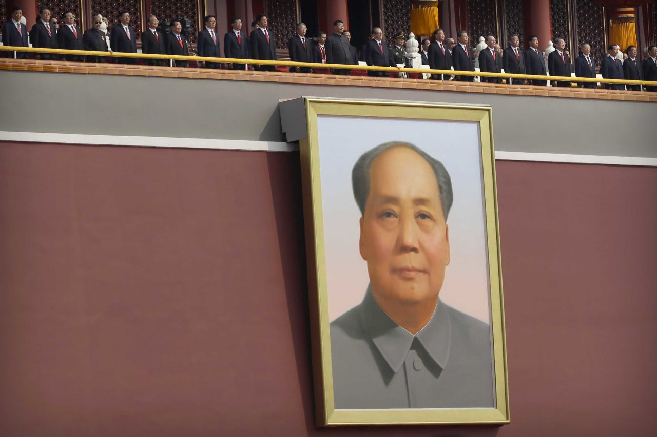 Chinese leaders including President Xi Jinping, center, stand on Tiananmen Gate above the large portrait of the late Chinese leader Mao Zedong.