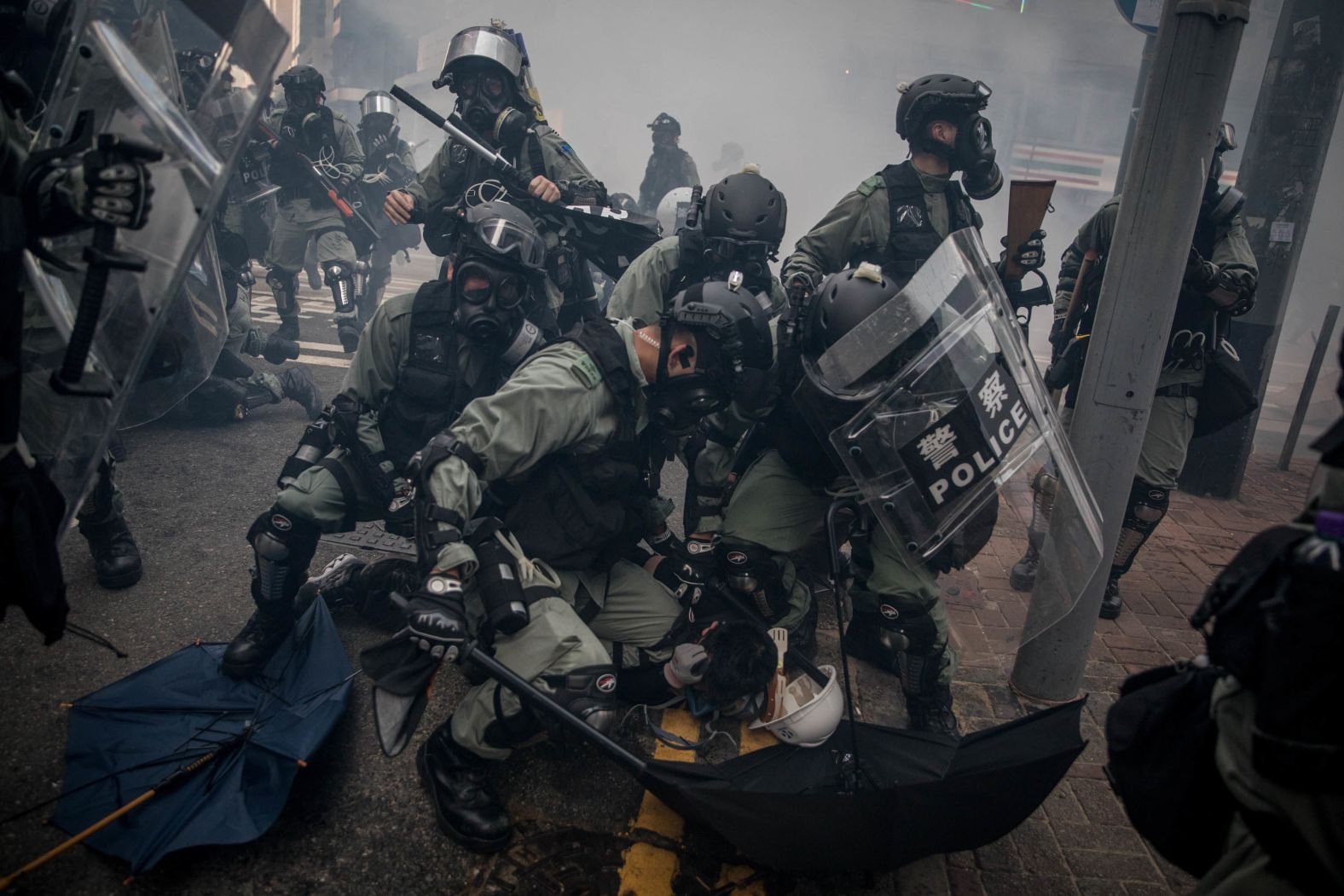 Police tackle and arrest pro-democracy protesters during clashes on October 1. 